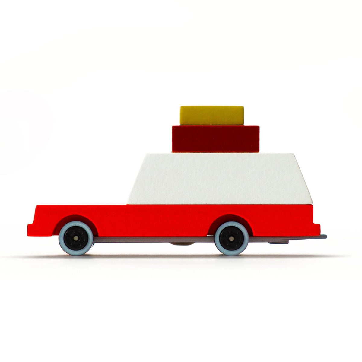Toy truck with a red base, white top, and yellow and red blocks on a white background