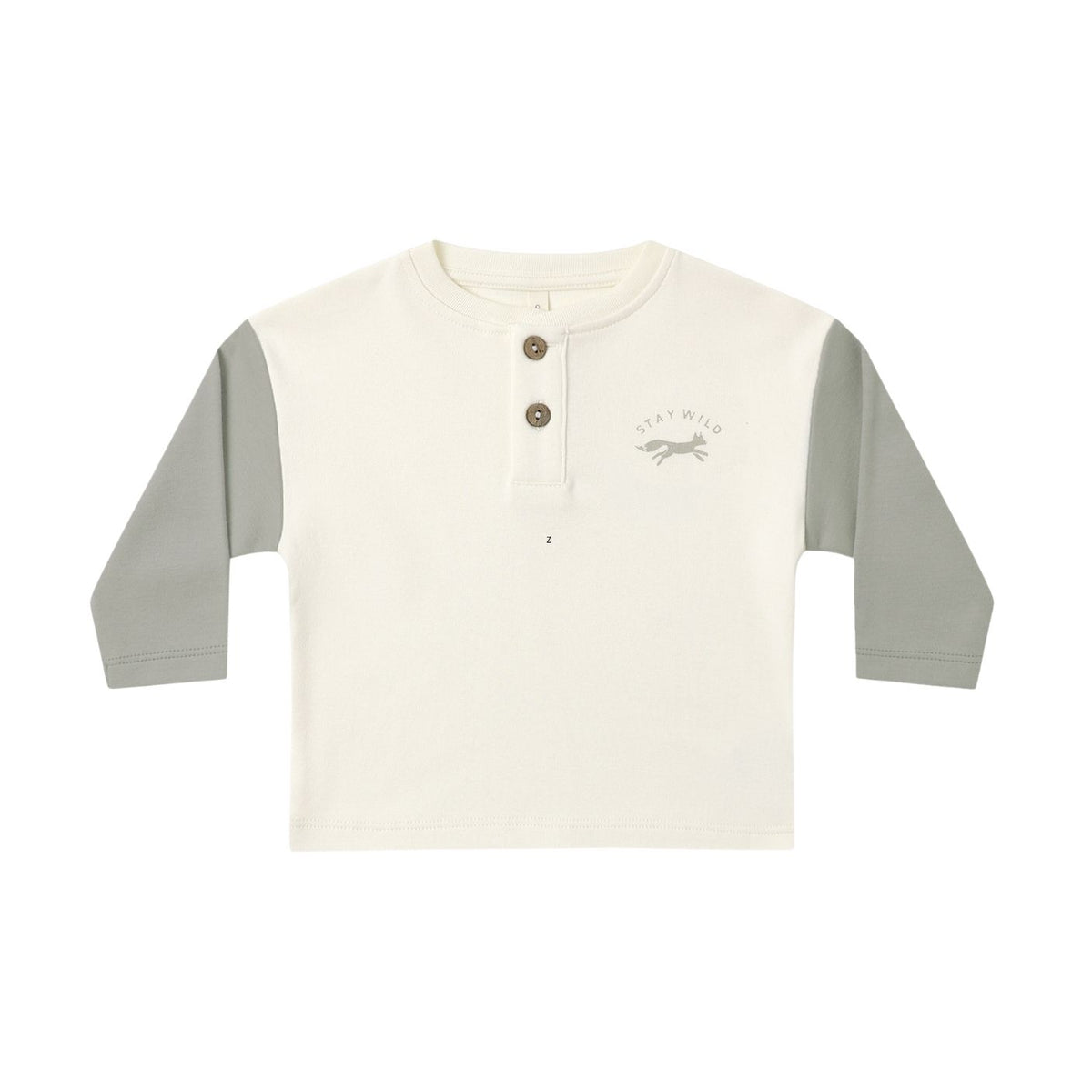 A children's long-sleeve henley shirt in off-white with sage green sleeves, featuring a three-button placket and a small 'stay wild' graphic on the left chest, displayed on a clean white background.