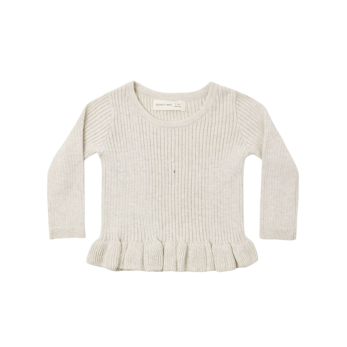 A cream-colored ribbed knit sweater with long sleeves and a ruffled hem, shown flat against a white background.