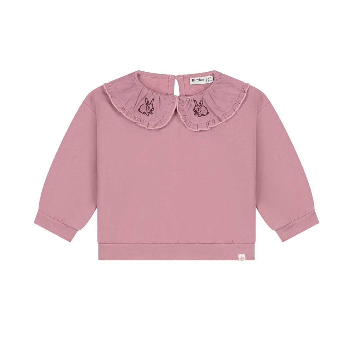 A dusty pink long-sleeve top for toddlers, featuring a ruffled Peter Pan collar with embroidered bunny motifs on each side, shown against a plain white background.