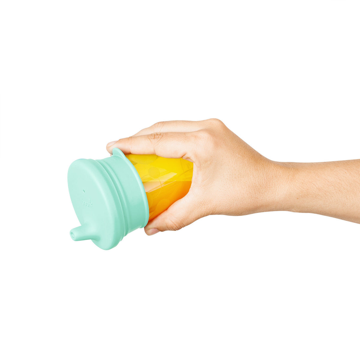 Hand holding a yellow silicone sleeve with a teal lid on a white background