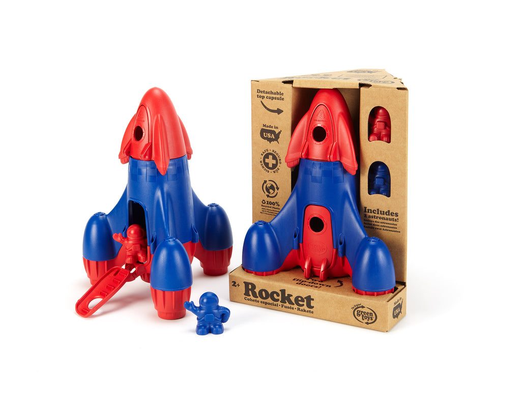 Toy rocket with red and blue design next to its packaging on a white background