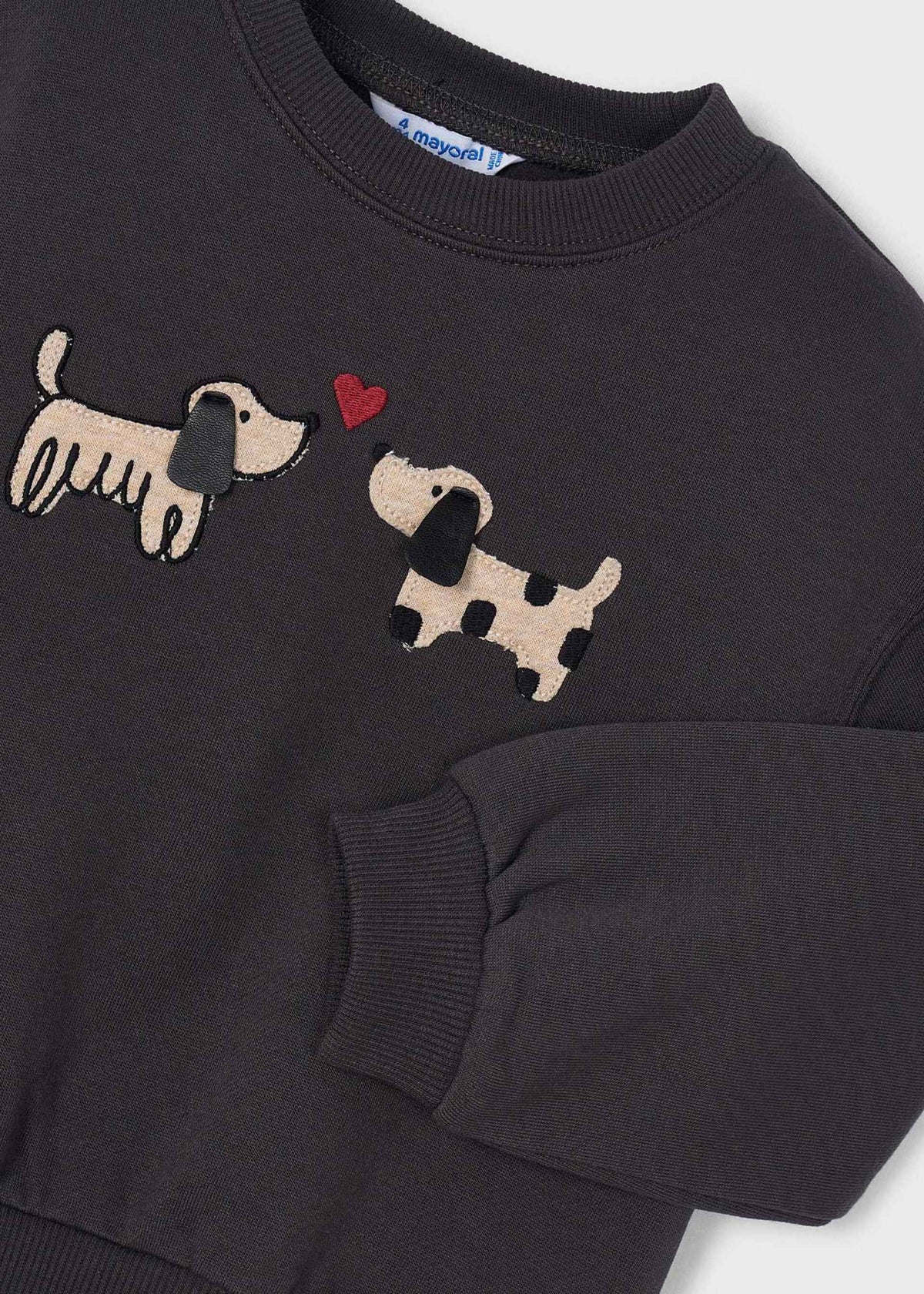 A close-up of a dark charcoal gray crewneck sweatshirt featuring two embroidered dachshund dogs and a small red heart on the chest.
