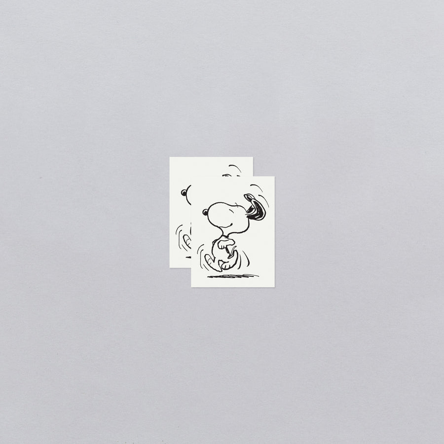 Two black and white illustrations of a dog on a gray background