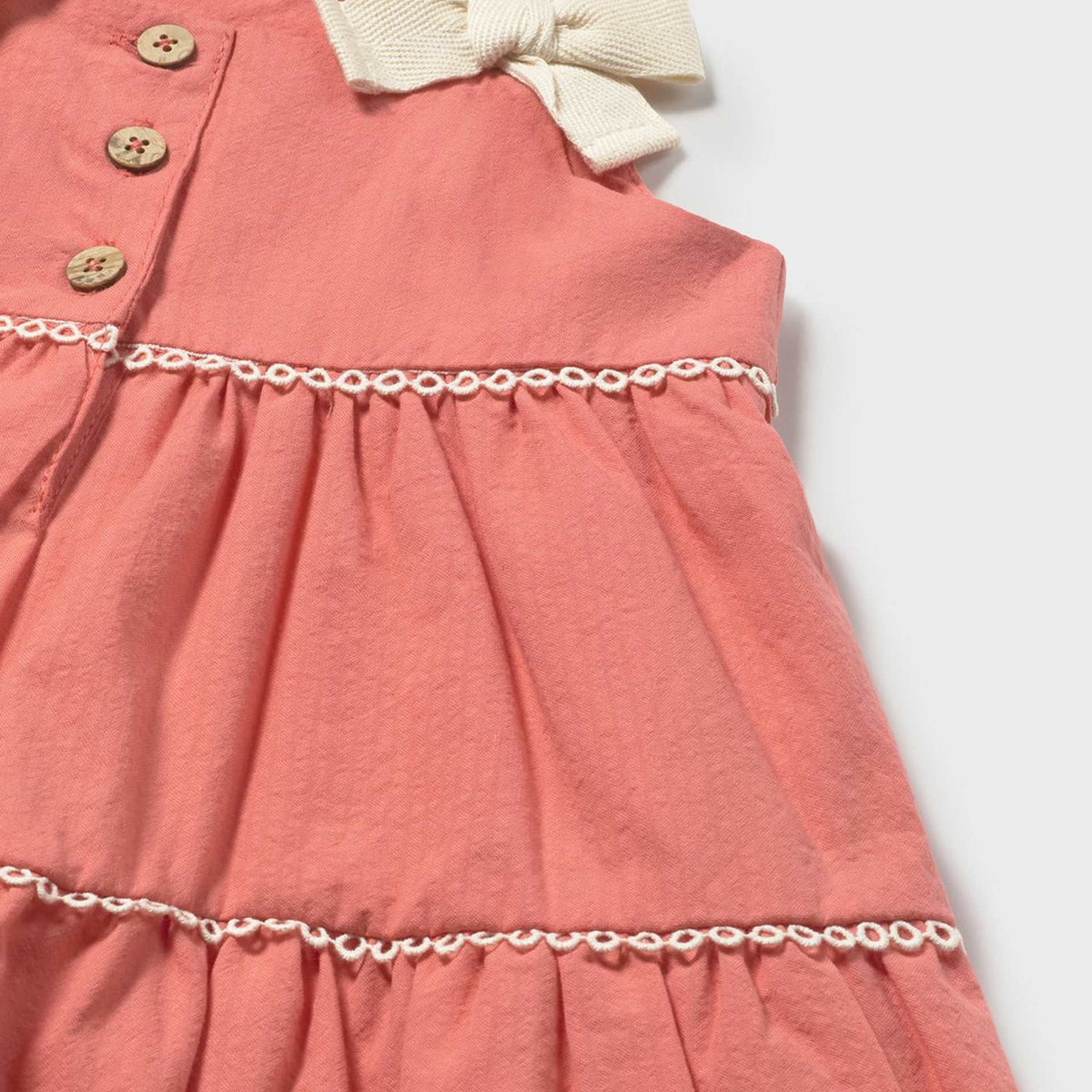 Pink dress with a bow detail on a white background