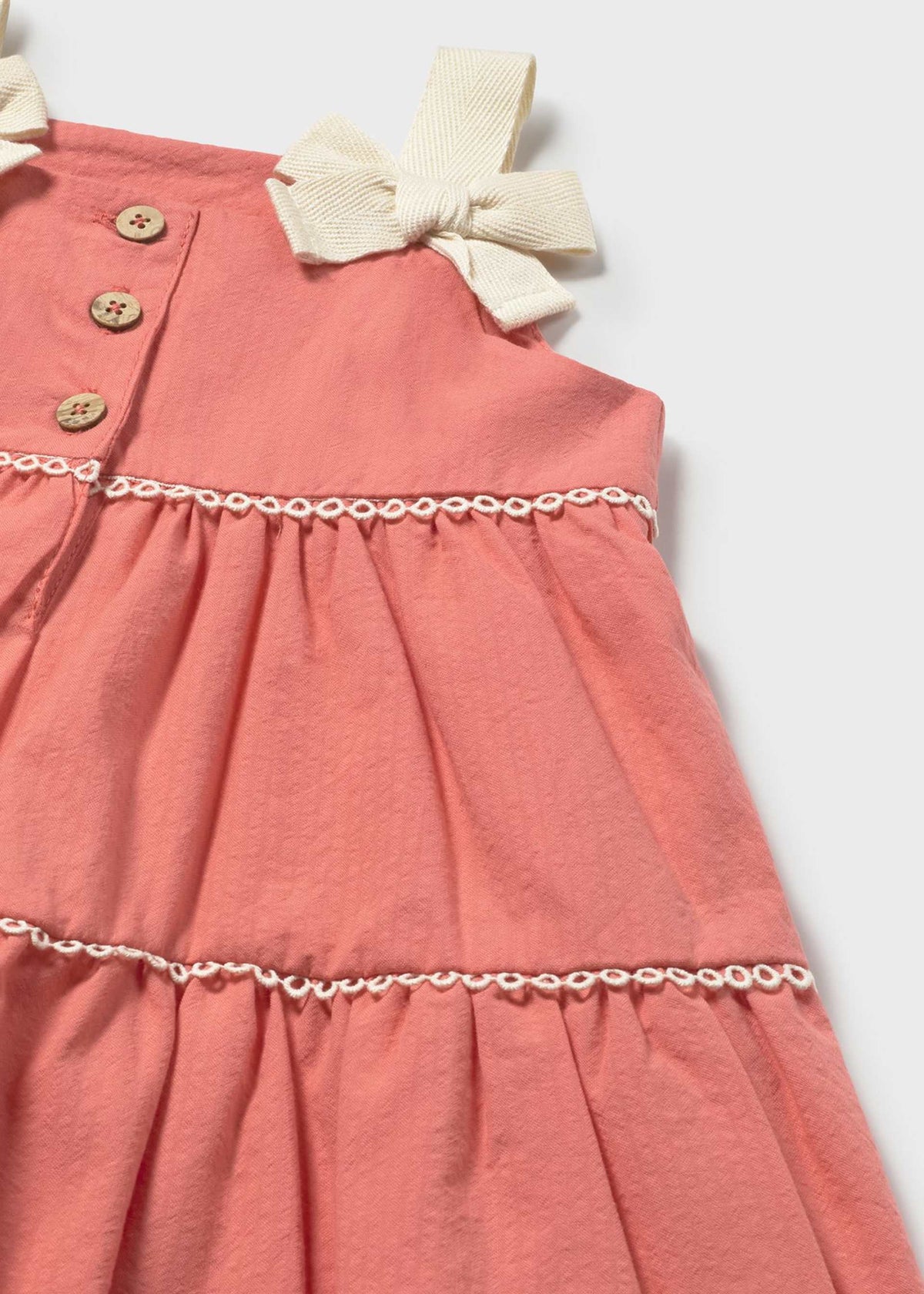 Pink dress with a bow detail on a white background