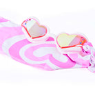 Pink and white striped swimsuit with heart-shaped sunglasses on a white background