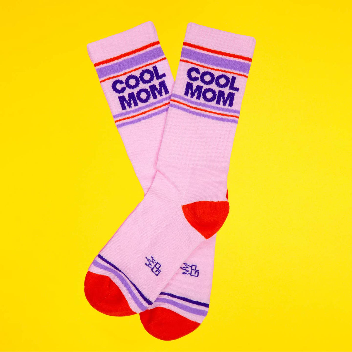 Pink socks with 'Cool Mom' text on a yellow background