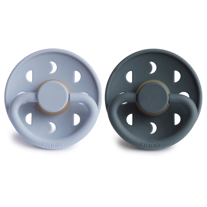 Two baby pacifiers, one light blue and one dark gray, on a white background.