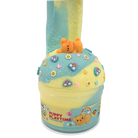 A novelty slime container labeled 'PUPPY PLAYTIME' filled with two-toned pastel blue and yellow slime, topped with a small orange bear figure and decorated with colorful flower and rainbow charms, on a plain white background.