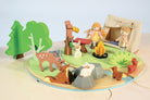 Wooden toy set with animals and people in a forest scene