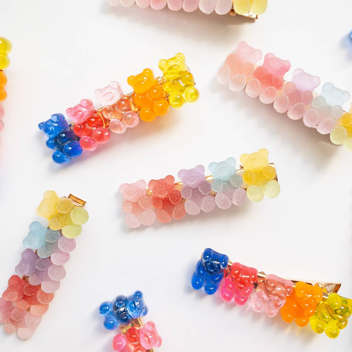 Colorful gummy bear-shaped hair clips on a white background