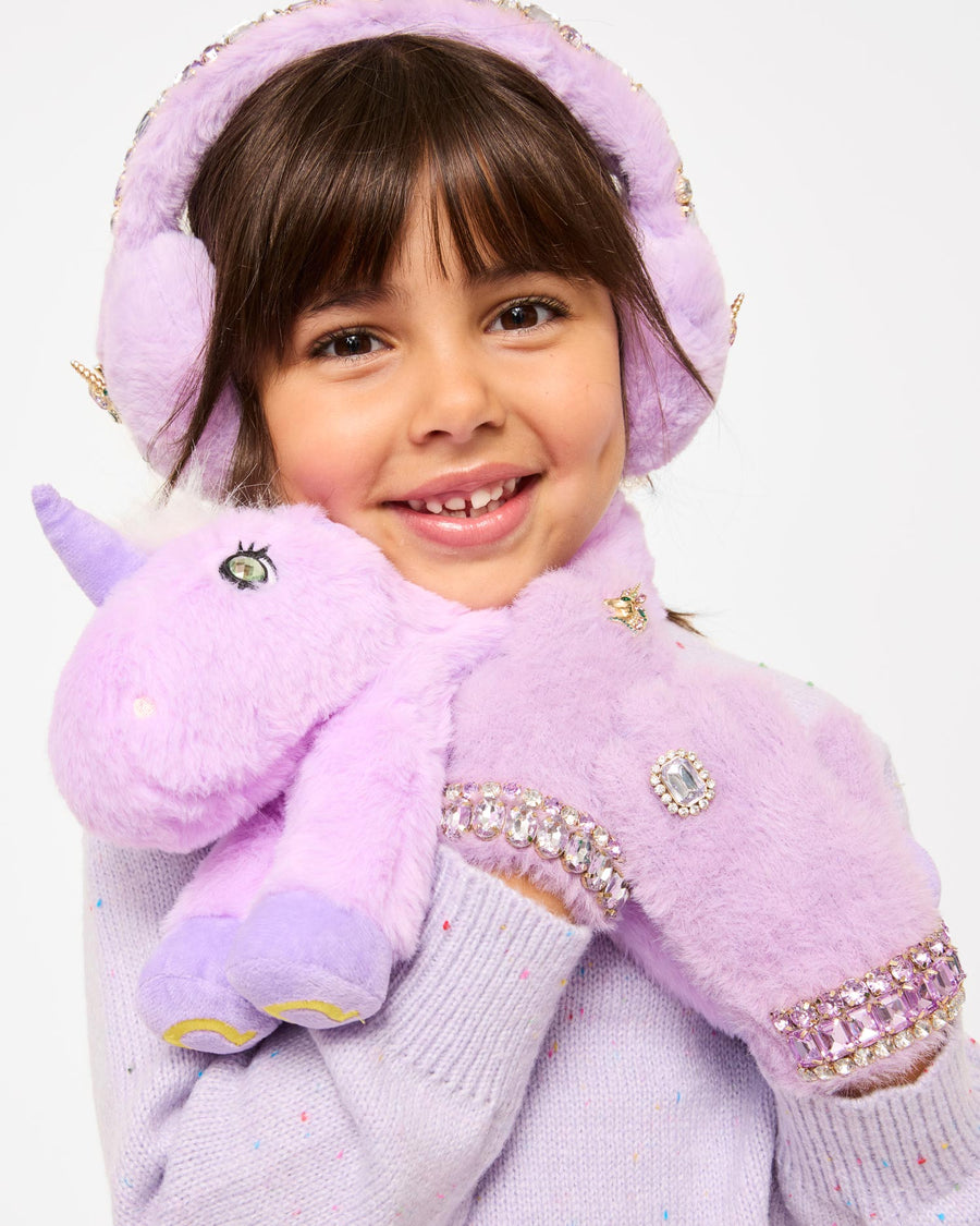 Child wearing a purple unicorn costume with rhinestone details on a white background