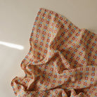 Patterned fabric with red, blue, and yellow squares on a white background