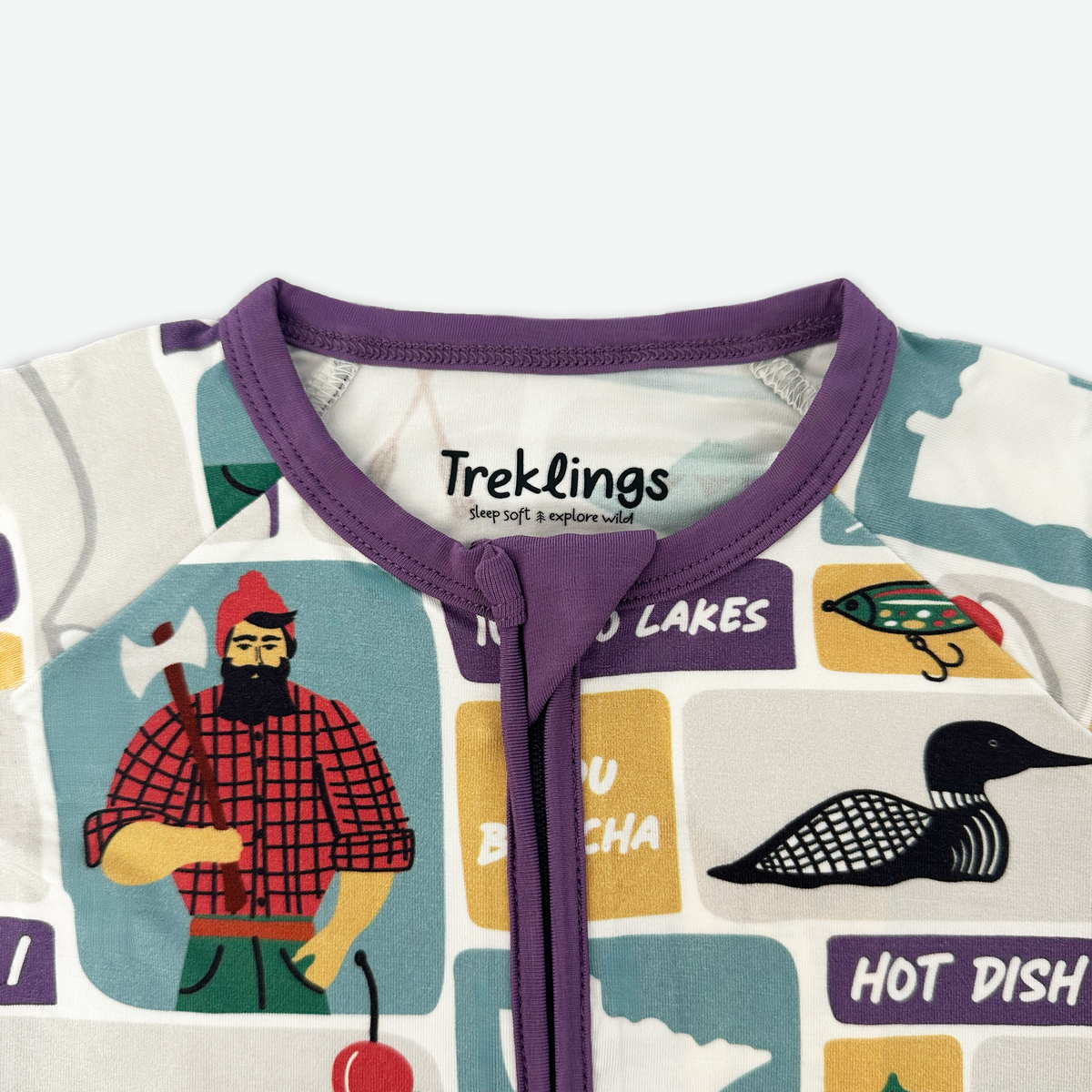 Children's onesie with purple neckline and nature-themed graphics on a white background