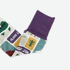Folded fabric with colorful patterns and text on a white background