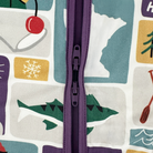 Close-up of a colorful fabric with a zipper running vertically through it, featuring various abstract shapes and patterns.