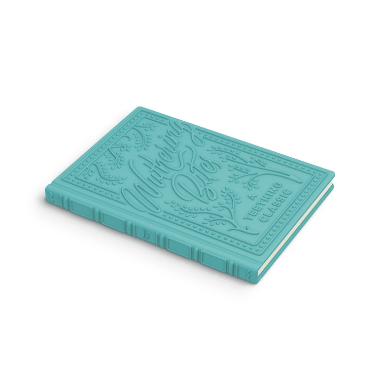 A turquoise hardcover notebook with embossed decorative lettering and border details on the cover, shown at an angle on a clean white background.