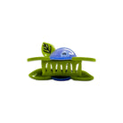 Green hair clip with a blue ball on a white background