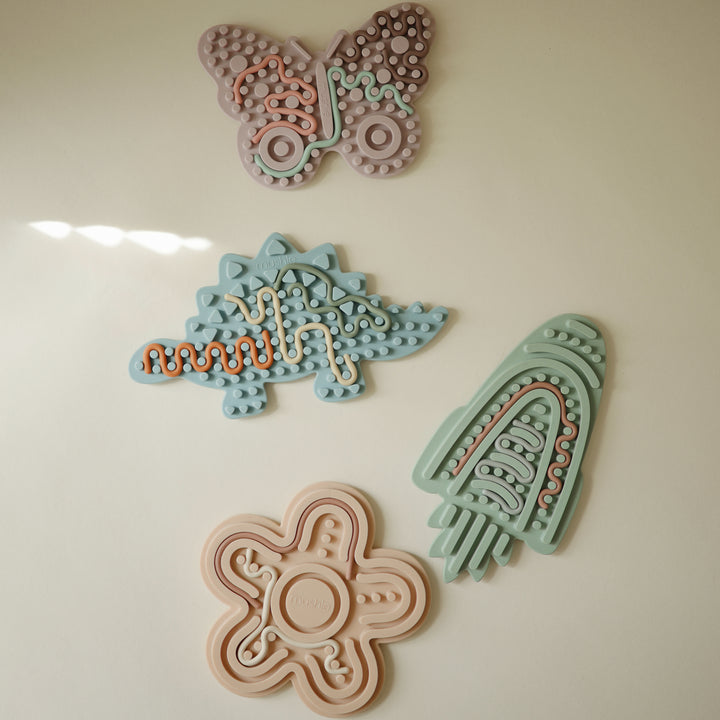 Colorful decorative items including flowers and geometric shapes on a light background
