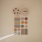 Decorative wall art with colorful circles and rectangular shapes on a beige background