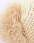 Close-up of beige fur and knitted fabric texture