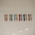 Row of baby teethers in various colors on a light background