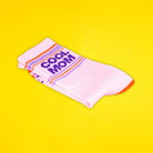 Pink socks with 'Cool Mom' text on a yellow background