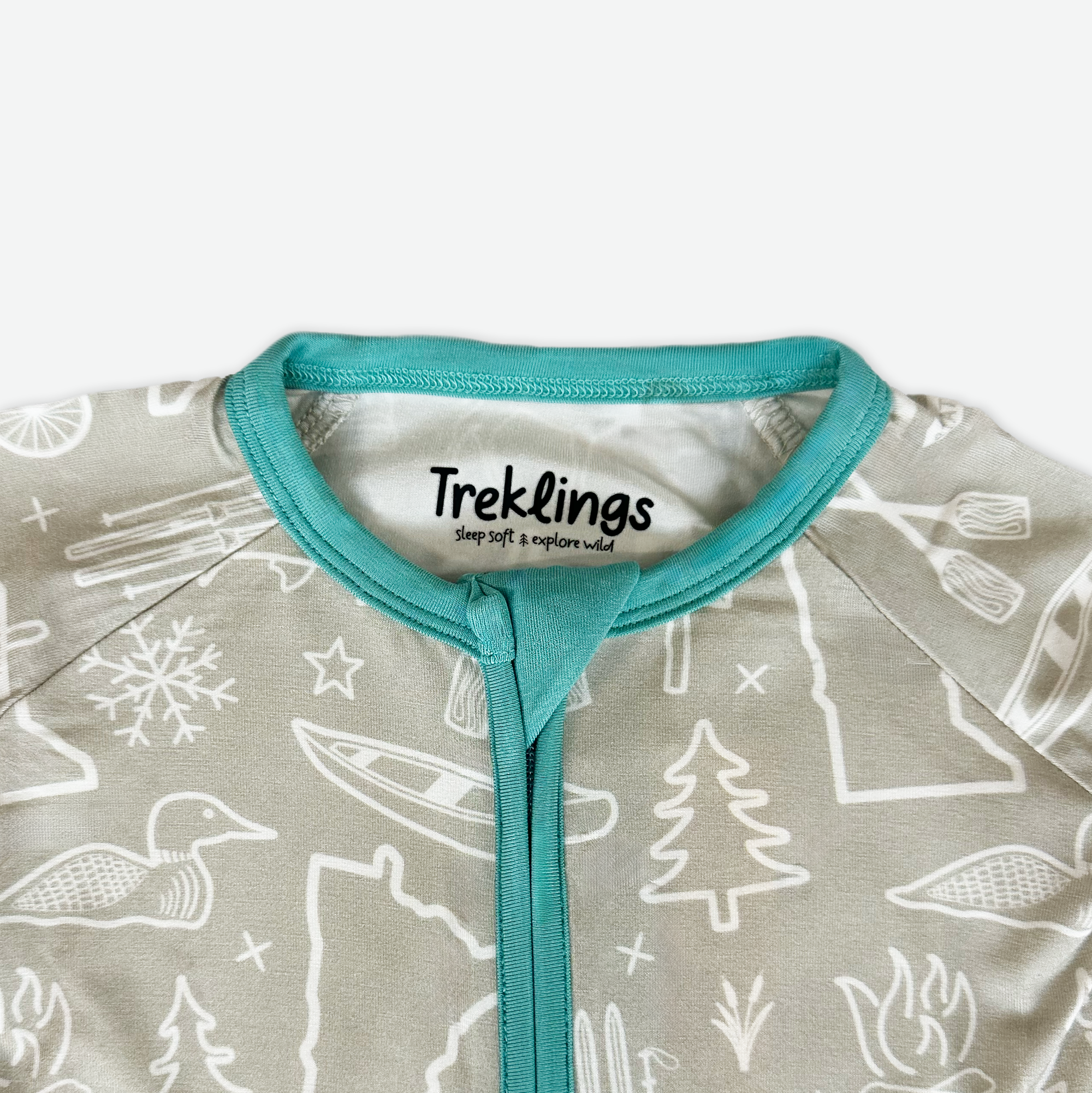 Baby onesie with nature-themed print and 'Treklings' label on a white background