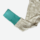 Teal pillowcase with beige fabric featuring white line art on a white background