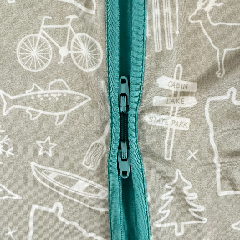 Pouch with teal zipper featuring white illustrations of a bicycle, fish, canoe, and trees on a gray background.