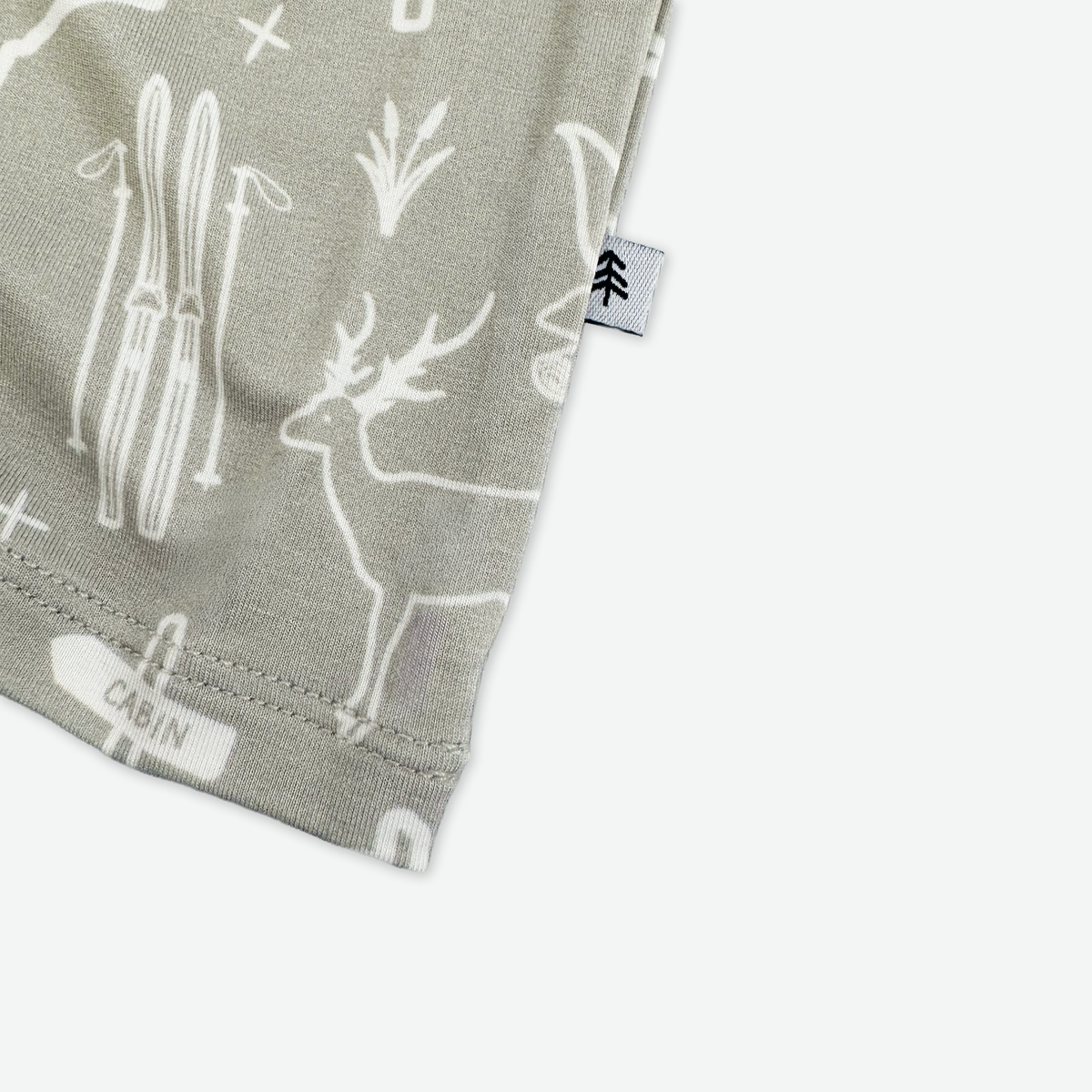 Fabric with deer and cabin pattern on a gray background