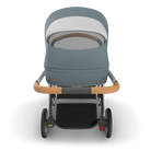 Gray and black stroller with wooden handle on a white background