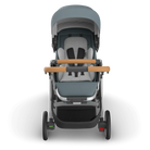 Gray and black stroller with wooden handles on a white background