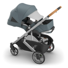 Gray and black stroller with a baby seat on a white background