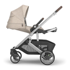 Baby stroller with beige canopy on a white background