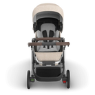 Baby stroller with beige canopy and seat on a white background