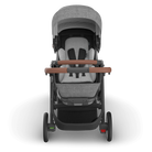 Gray and black stroller with brown handles on a white background