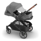 Gray and black stroller with a baby seat on a white background