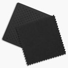 Two black textured square mats on a white background