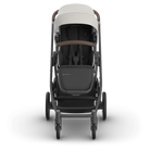 Stroller with beige top and dark body on a white background