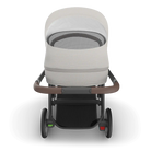 Baby stroller with a white cover on a white background