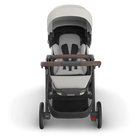 Baby stroller with white seat and brown handle on a white background