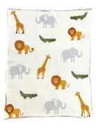 knit blanket with a cream background and a pattern of giraffes, aligators, lions, and elephants.  the elephants ears are 3D