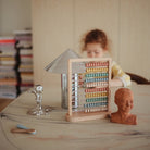 Abacus on a table with books and decorative items in the background