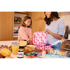Woman and child preparing a lunch together in a kitchen.