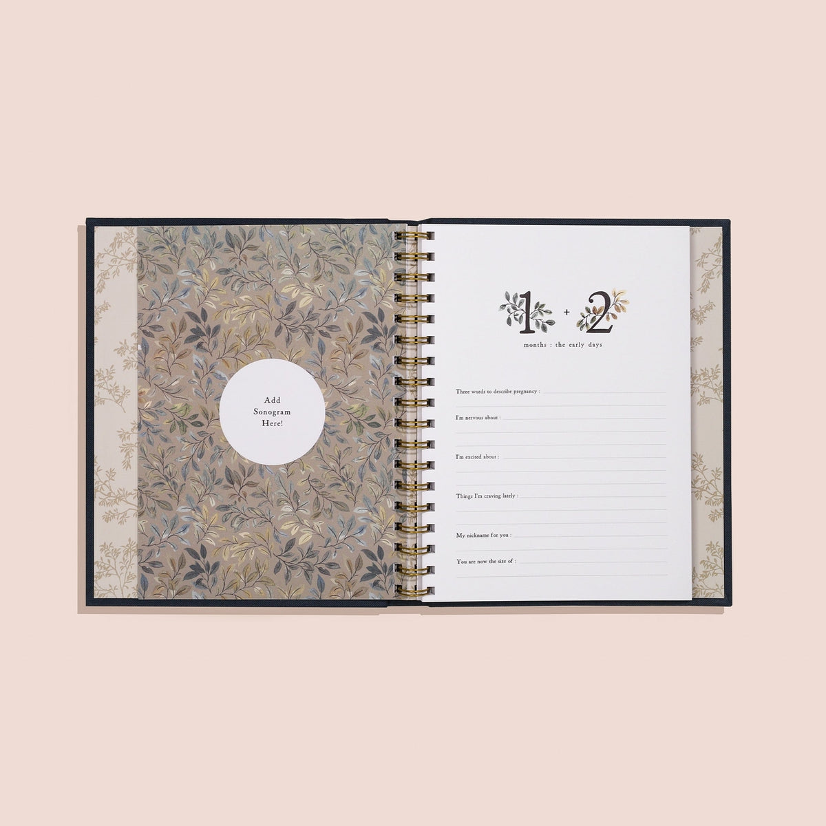 Open planner with floral design on cover and white pages on a beige background