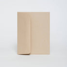 Two beige notebooks on a white background