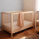 Wooden crib with a blanket in a nursery setting