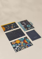 Set of space-themed notebooks and planners on a beige background